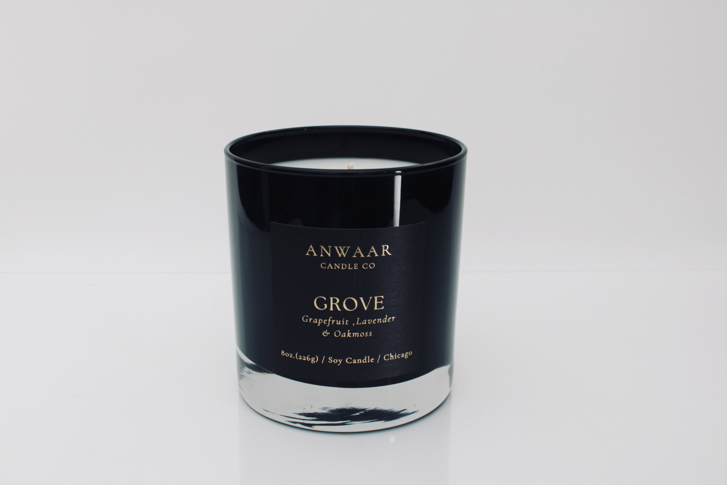 Grove - black elegant candle vessel with black label and gold letters with details about the product