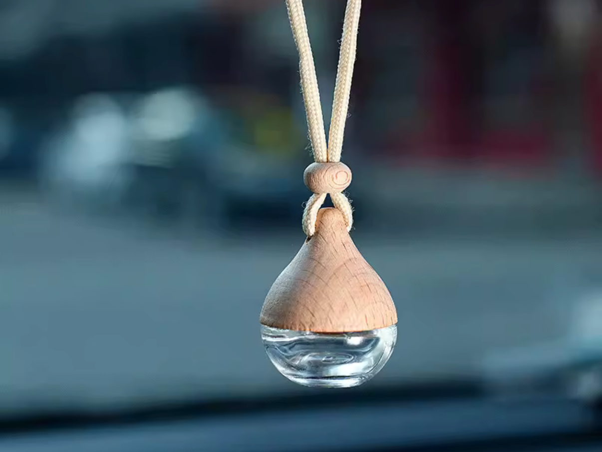 Wooden pendant with a clear droplet on a blurred background