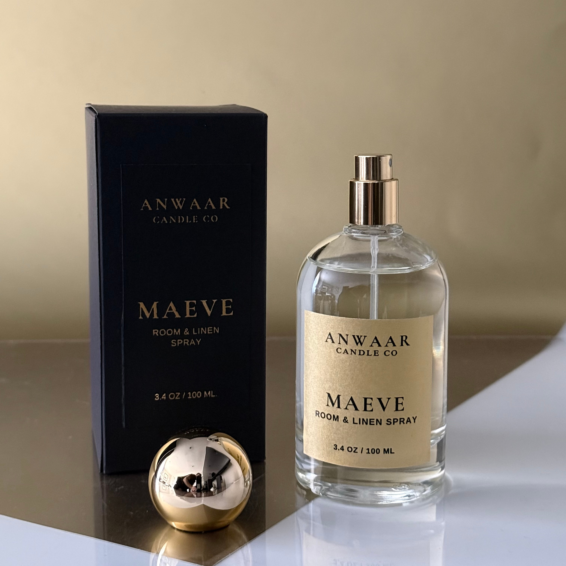 Anwaar Candle Co Maeve room and linen spray with packaging on a reflective surface.