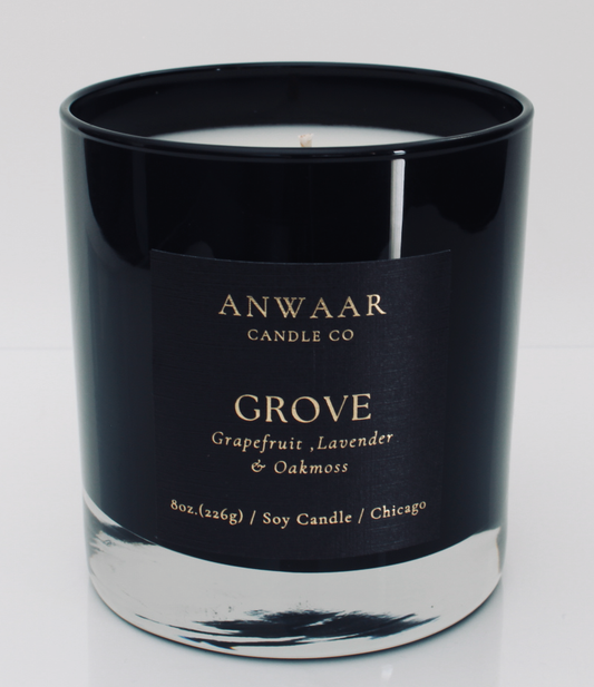 Grove - black elegant candle vessel with  black label and gold  letters with details about the product 